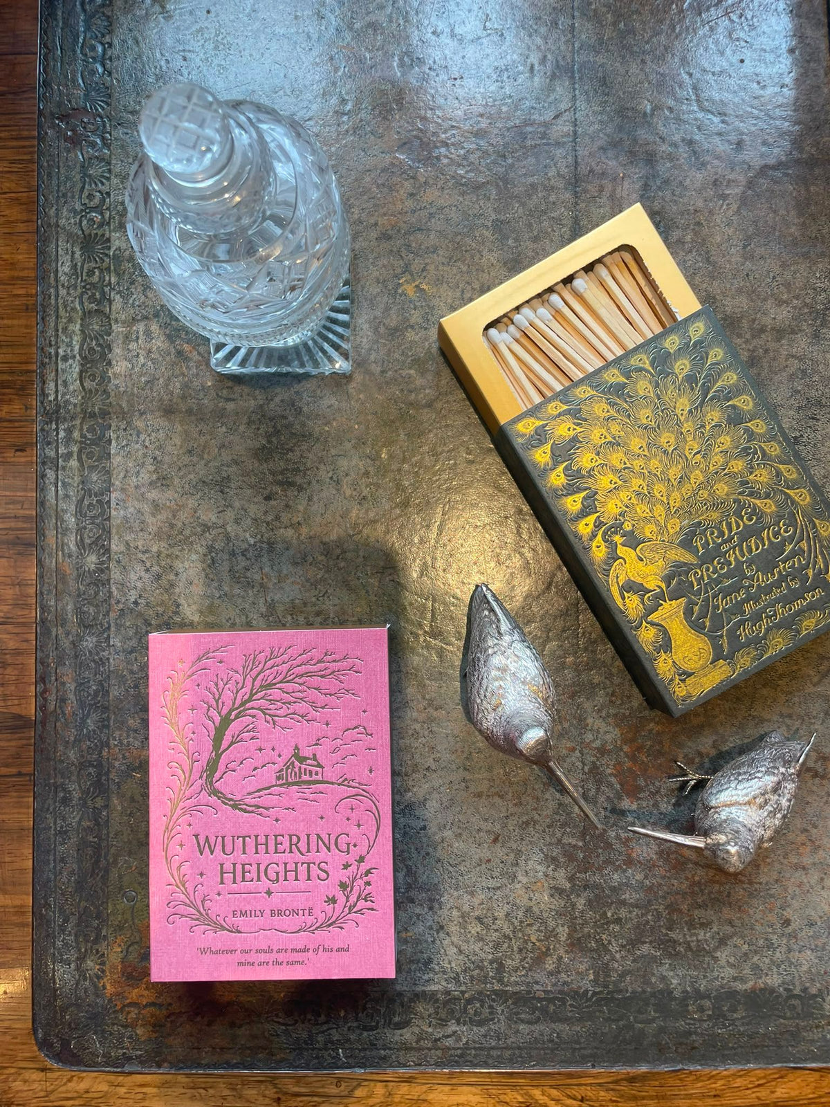 Pride and Prejudice matchbox styled with books and a glass decanter